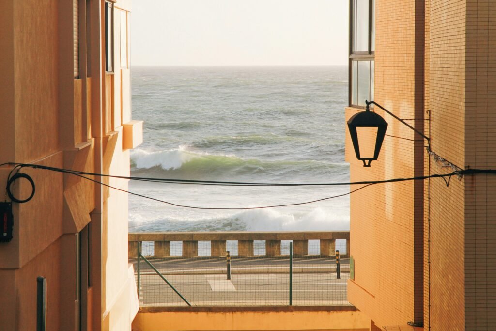 Scenic ocean view framed by buildings in Porto, Portugal.