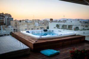 Experience relaxation in a balcony Jacuzzi overlooking a stunning Cypriot cityscape at sunset.