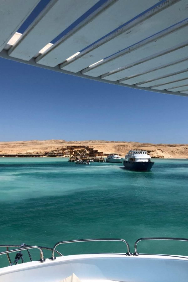 Scenic view of boats near the dock along Egypt's Red Sea coastline under clear blue skies.