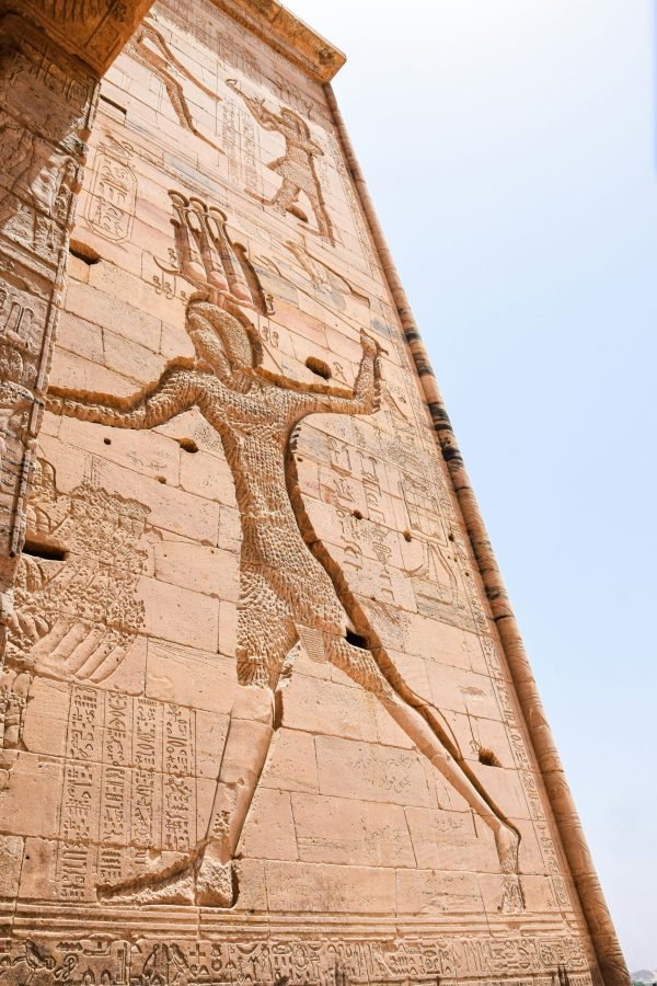 Detailed relief of ancient Egyptian artwork on a historic wall, showcasing hieroglyphs.