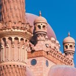 Intricate architecture of the Sahaba Mosque in Sharm El Sheikh under a clear blue sky.