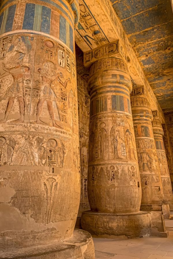 Intricately carved columns in the Luxor Temple, showcasing ancient Egyptian art and architecture.