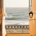 Scenic ocean view framed by buildings in Porto, Portugal.