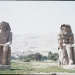 View of the Colossi of Memnon statues in Luxor, Egypt highlighting ancient Egyptian architecture.