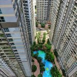 High-rise buildings with a courtyard pool in Ho Chi Minh City, showcasing urban architecture.