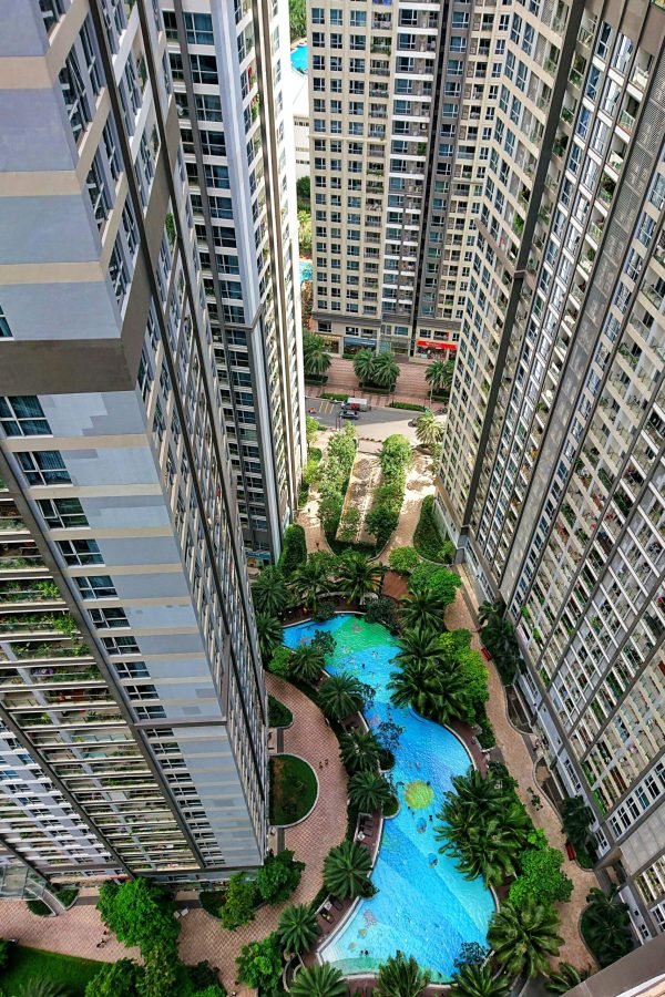 High-rise buildings with a courtyard pool in Ho Chi Minh City, showcasing urban architecture.